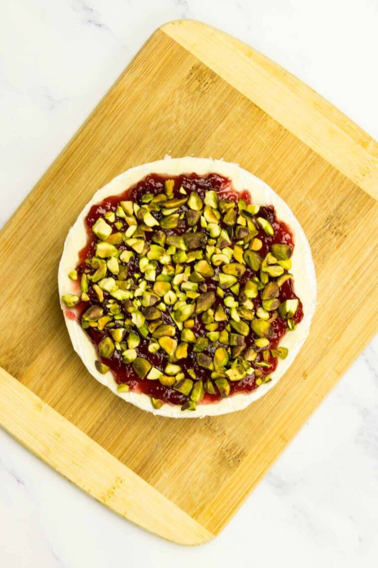 Cranberry sauce and pistachios on top of brie.