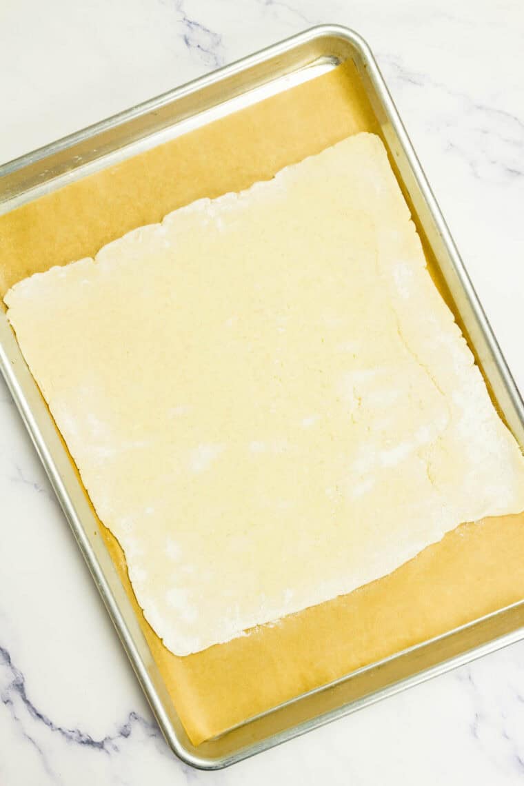 A square of crescent dough on a baking sheet.