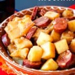 A bowl of chorizo and potatoes stew with text overlay that says "Patatas Riojana".