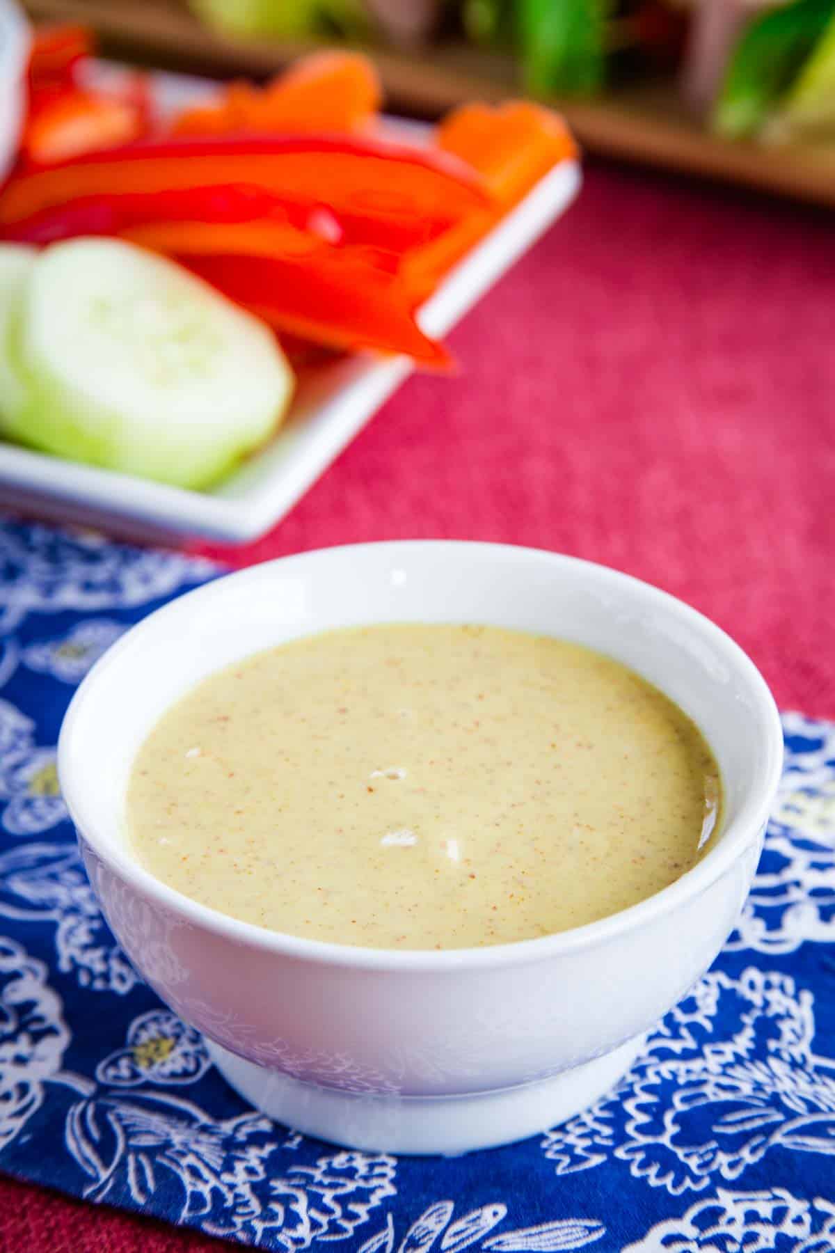 This 4-ingredient Honey Mustard Dipping Sauce is so versatile! A blend of spicy mustard, honey, and Greek yogurt makes a creamy dip. A white bowl of honey mustard dipping sauce.
