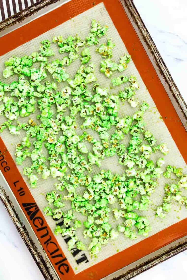 Green popcorn on a baking sheet.