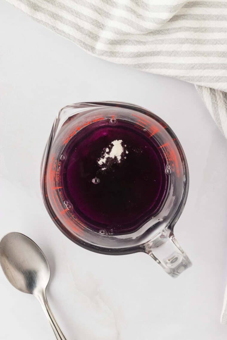 Flavored jello is added to the cup.