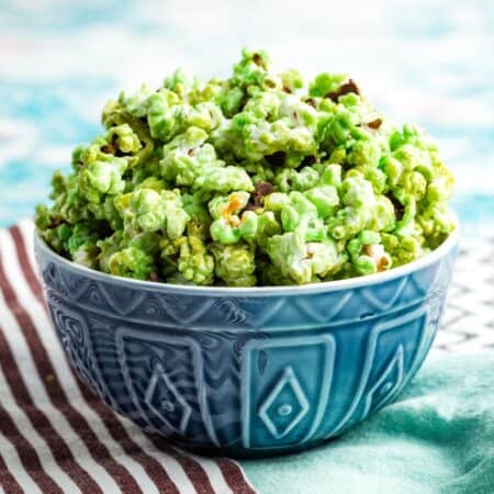 A blue bowl brims with mint green popcorn.