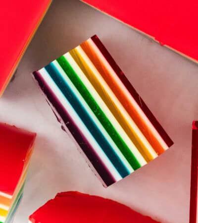 A square of layered rainbow jello on its side.