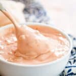A spoon in a bowl of a creamy pink sauce with text overlay that says "Homemade Big Mac Sauce".
