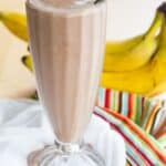 A smoothie in a tall milkshake glass with text overlay that says "Chocolate Peanut Butter Banana Smoothie".