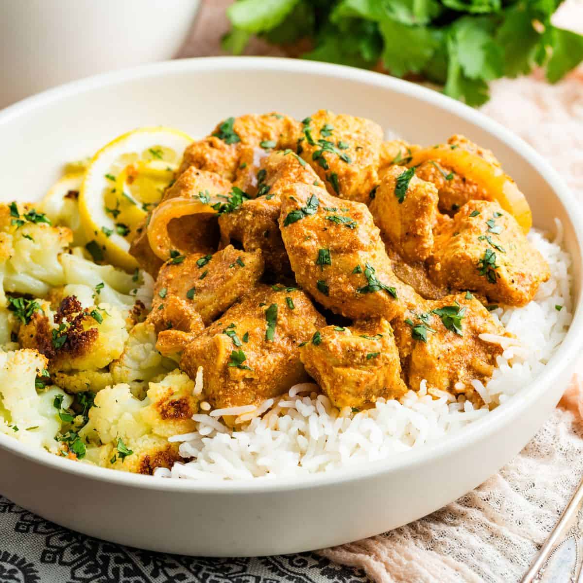 A bowl of slow cooker butter chicken and rice.