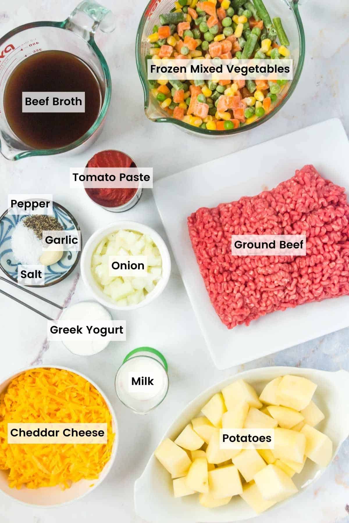 Ingredients to make mini shepherd's pies portioned out on a countertop with text labels.
