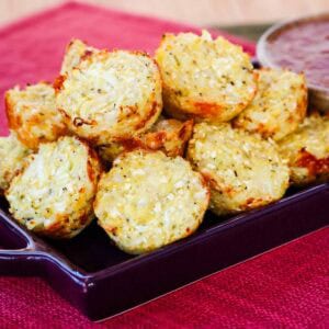 A pile of mozzarella cauliflower tots on a purple dish.