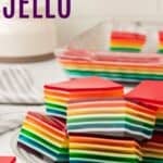 Cubes of jello layered with different colors on a plate with text overlay that says "Rainbow Jello".