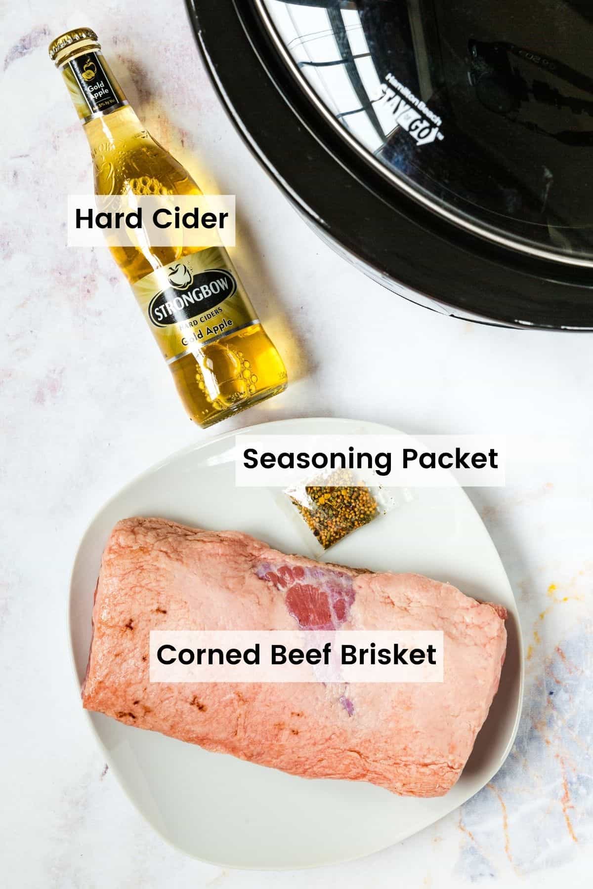 Ingredients to make slow cooker corned beef on a countertop next to a crockpot with text labels.