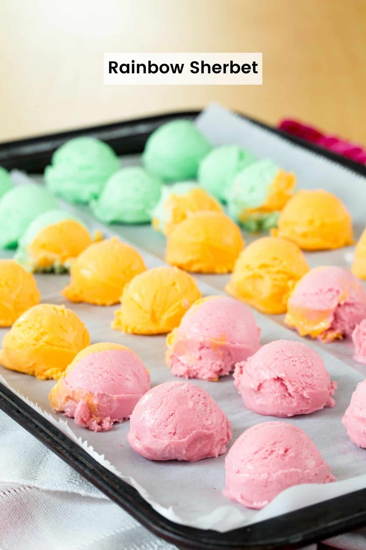 A sheet pan with small scoops of rainbow sherbet with a text label that says "Rainbow Sherbet".
