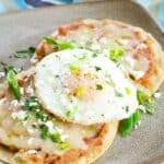 Crisp breakfast tostadas are topped with fried eggs.