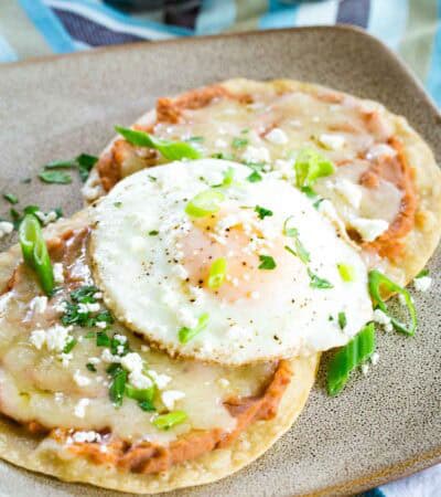 Crisp breakfast tostadas are topped with fried eggs.