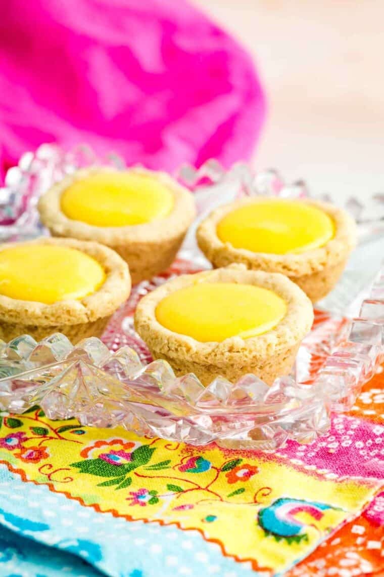 A tray of sugar cookie cups filled with lemon curd.