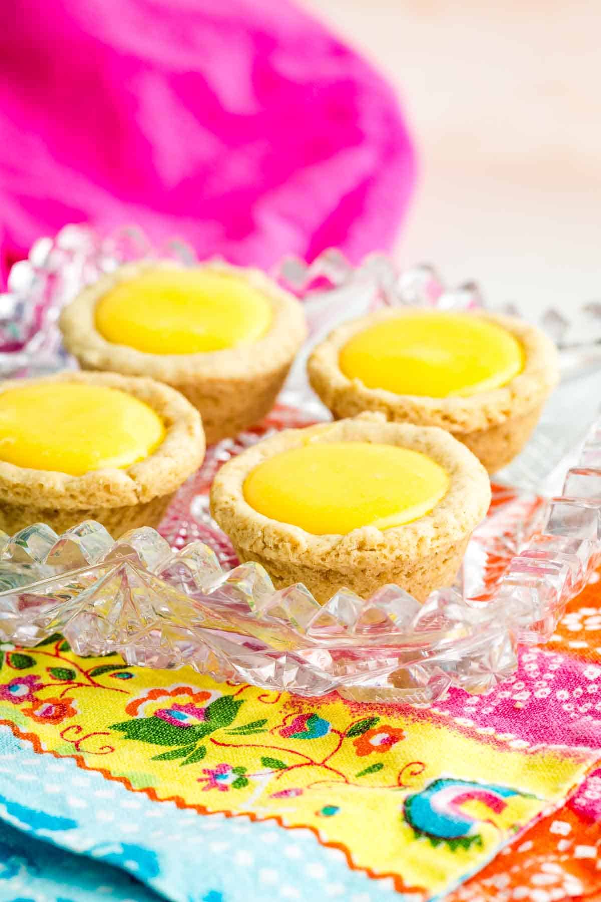 A tray of sugar cookie cups filled with lemon curd.
