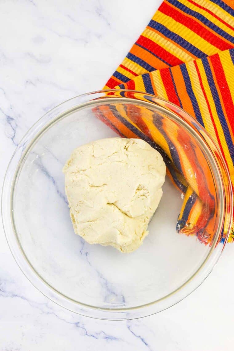 Corn tortillas dough in a ball in a bowl.