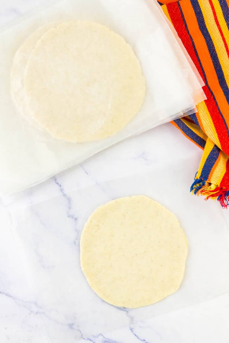 A corn tortilla pressed out flat.