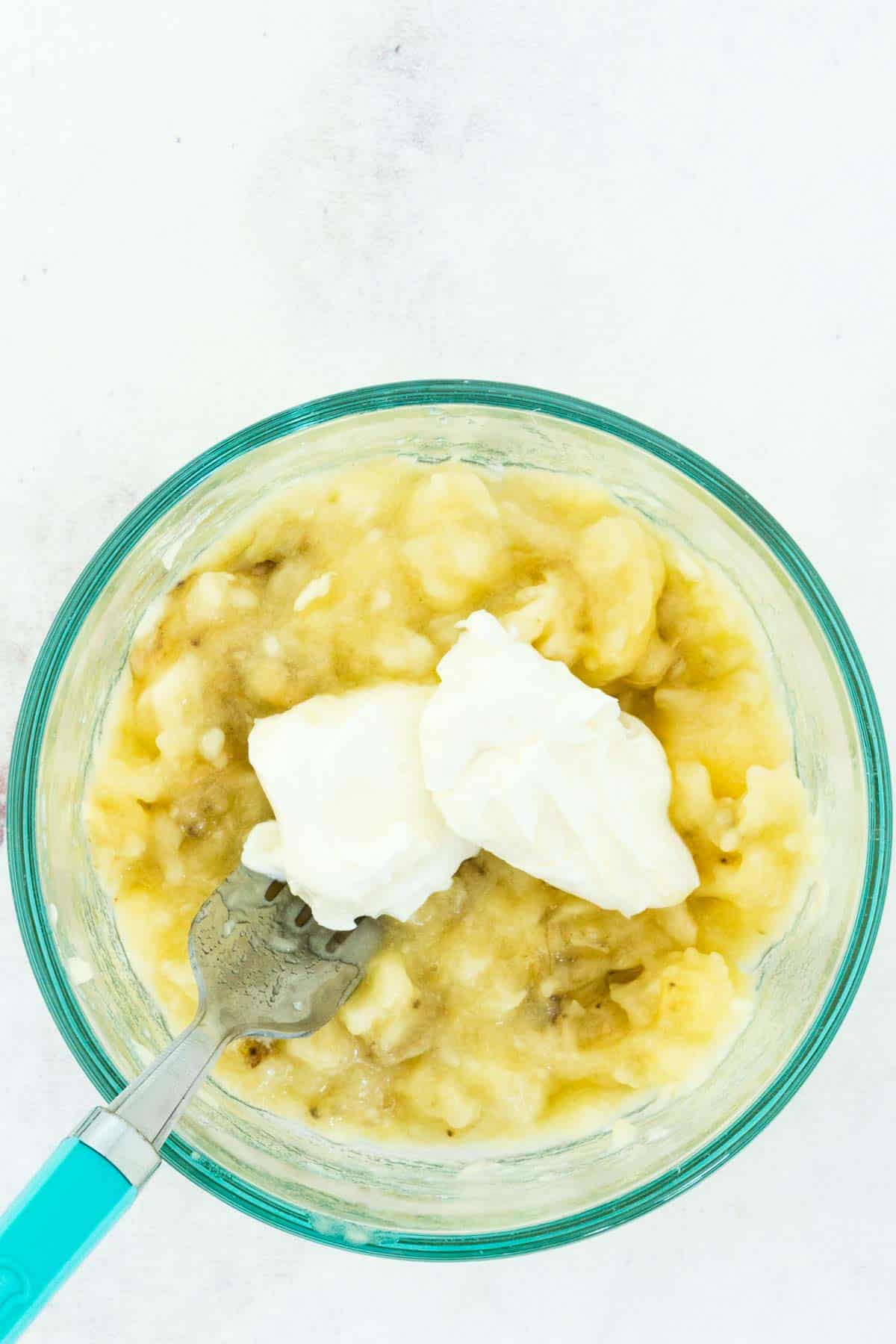 Mashed banana and cream cheese in a bowl.