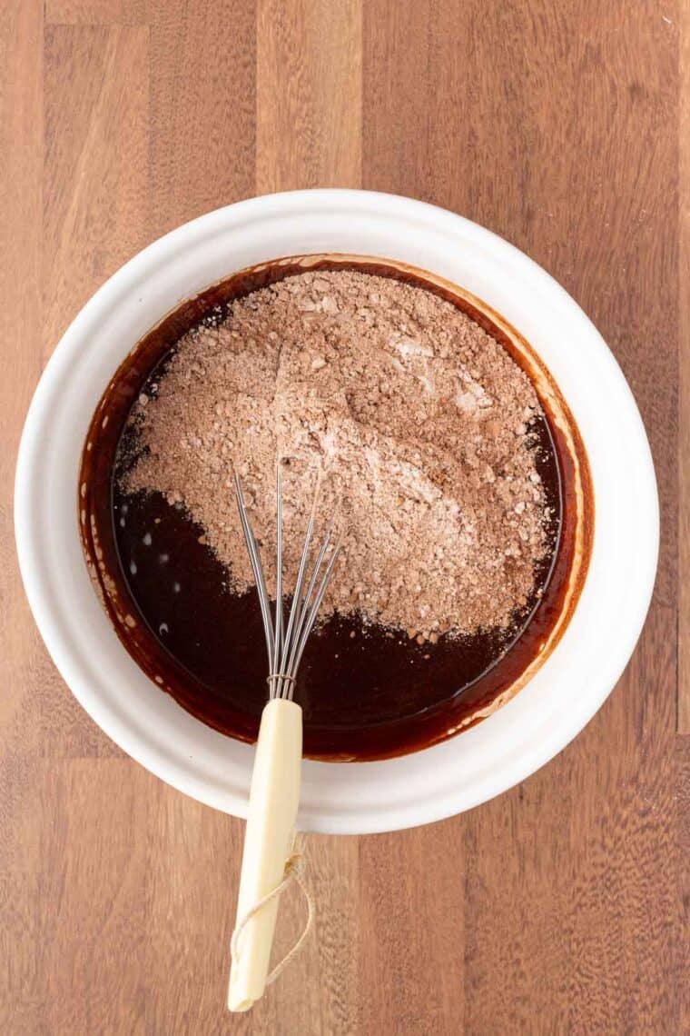 The dry mix for Mexican brownies is whisked into the wet mix.