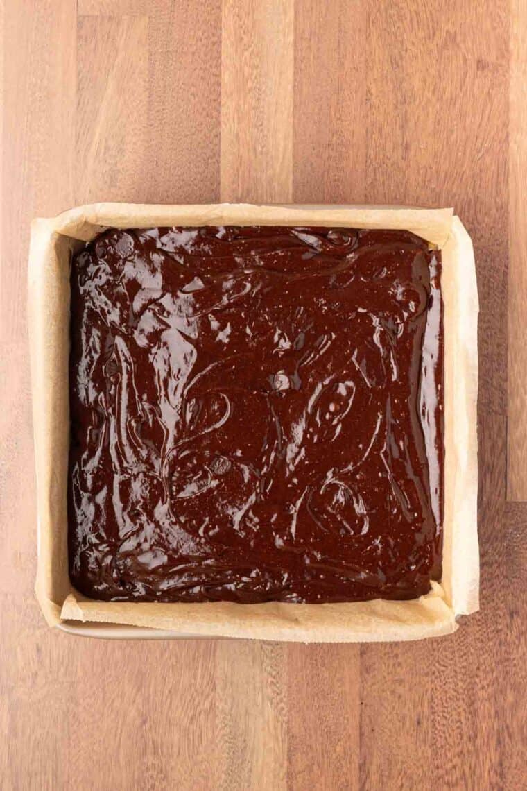 Mexican brownies batter placed in a baking pan.