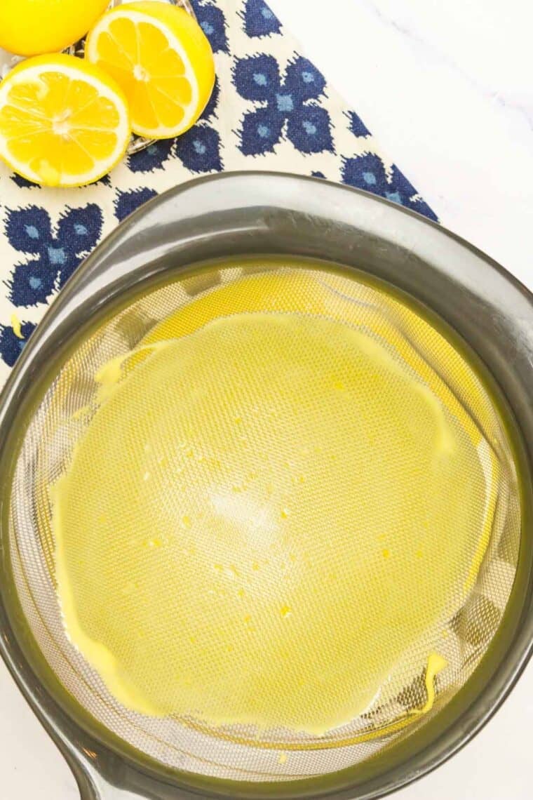 Lemon curd strained through a sieve.