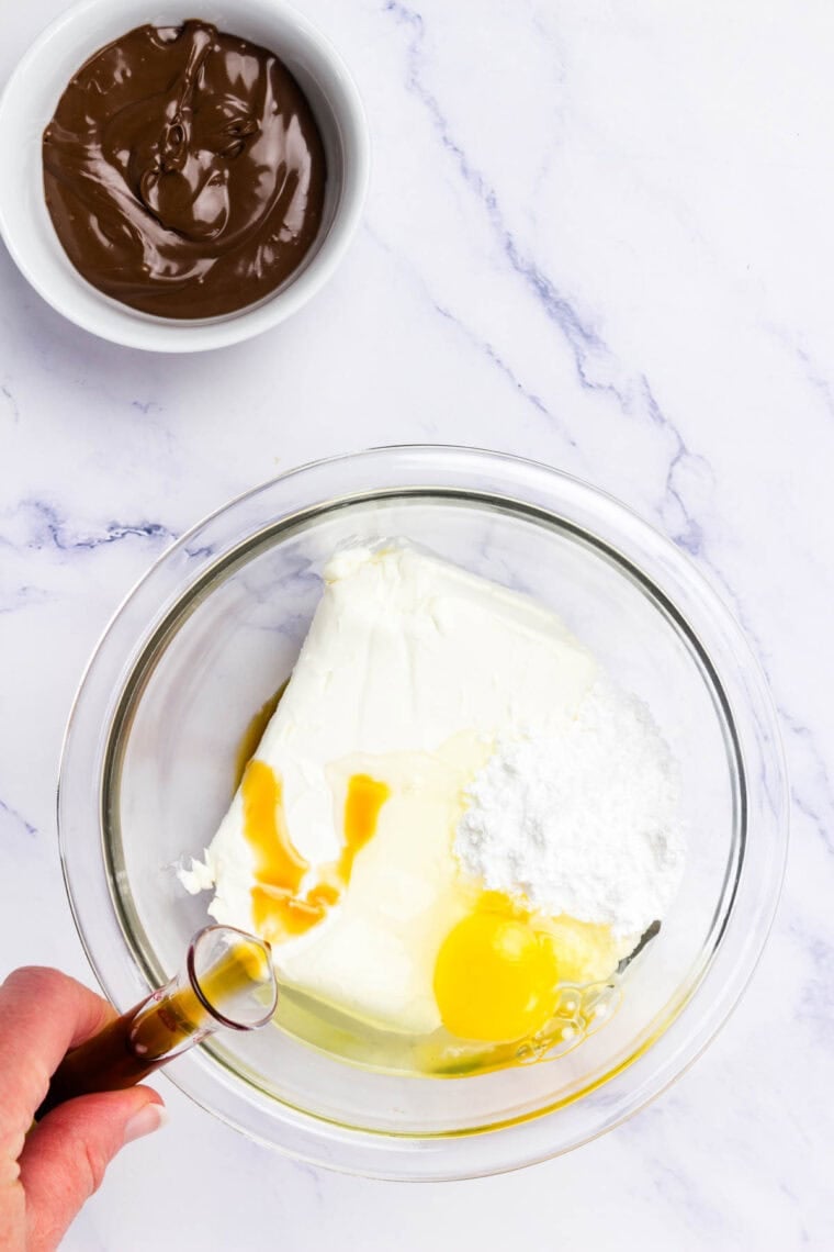 Ingredients for cream cheese filling for Nutella pastry are mixed in a bowl.