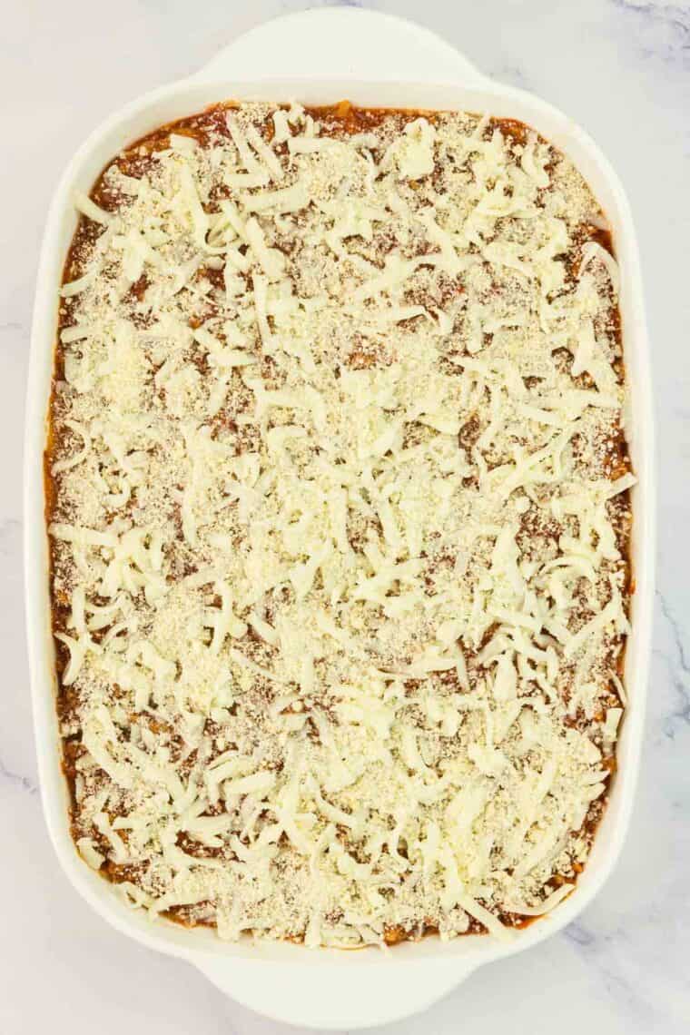 Shredded mozzarella is spread over the top of a spaghetti squash lasagna.