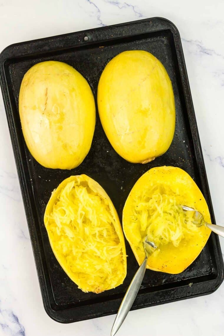 Baked spaghetti squash is scraped out with a fork.