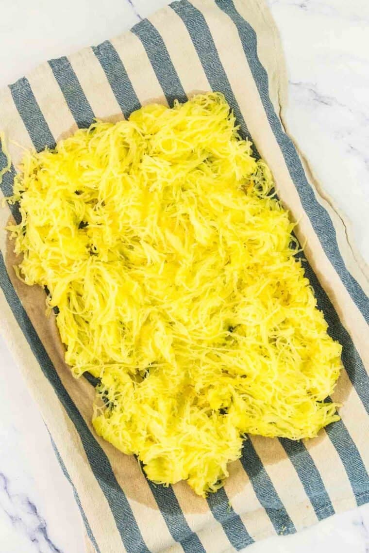 Baked spaghetti squash on a towel.