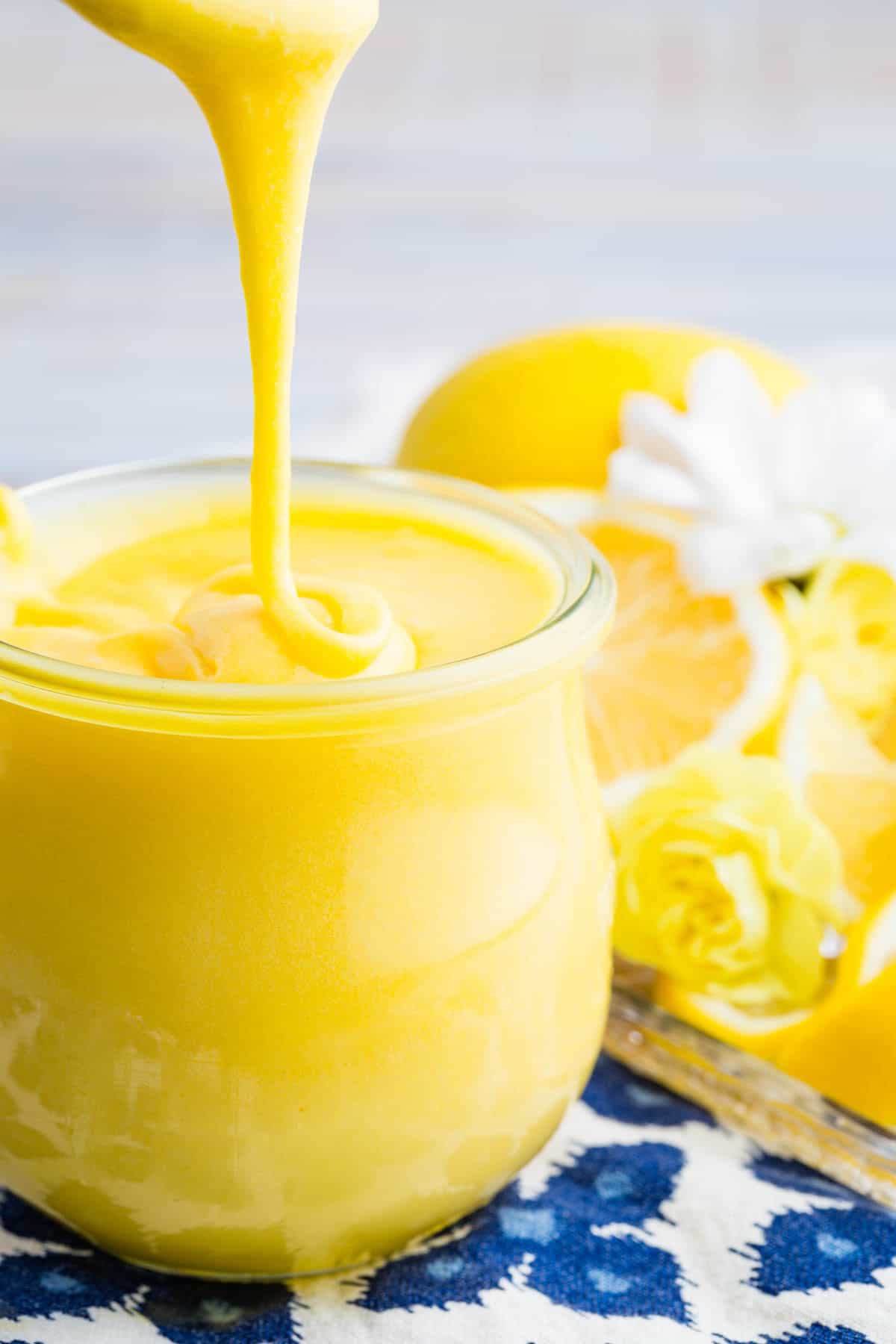 This lemon curd recipe makes a bright batch of sweet-tart, silky smooth lemon curd that's great with cake, cookies, and more. Lemon curd drips into a jar from a spoon.