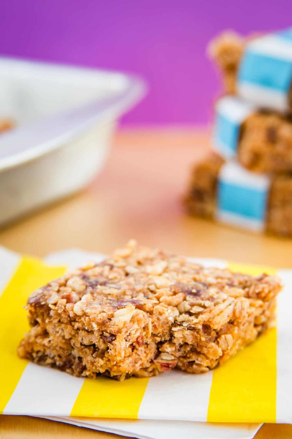 A no bake granola bar on a yellow and white striped napkin.