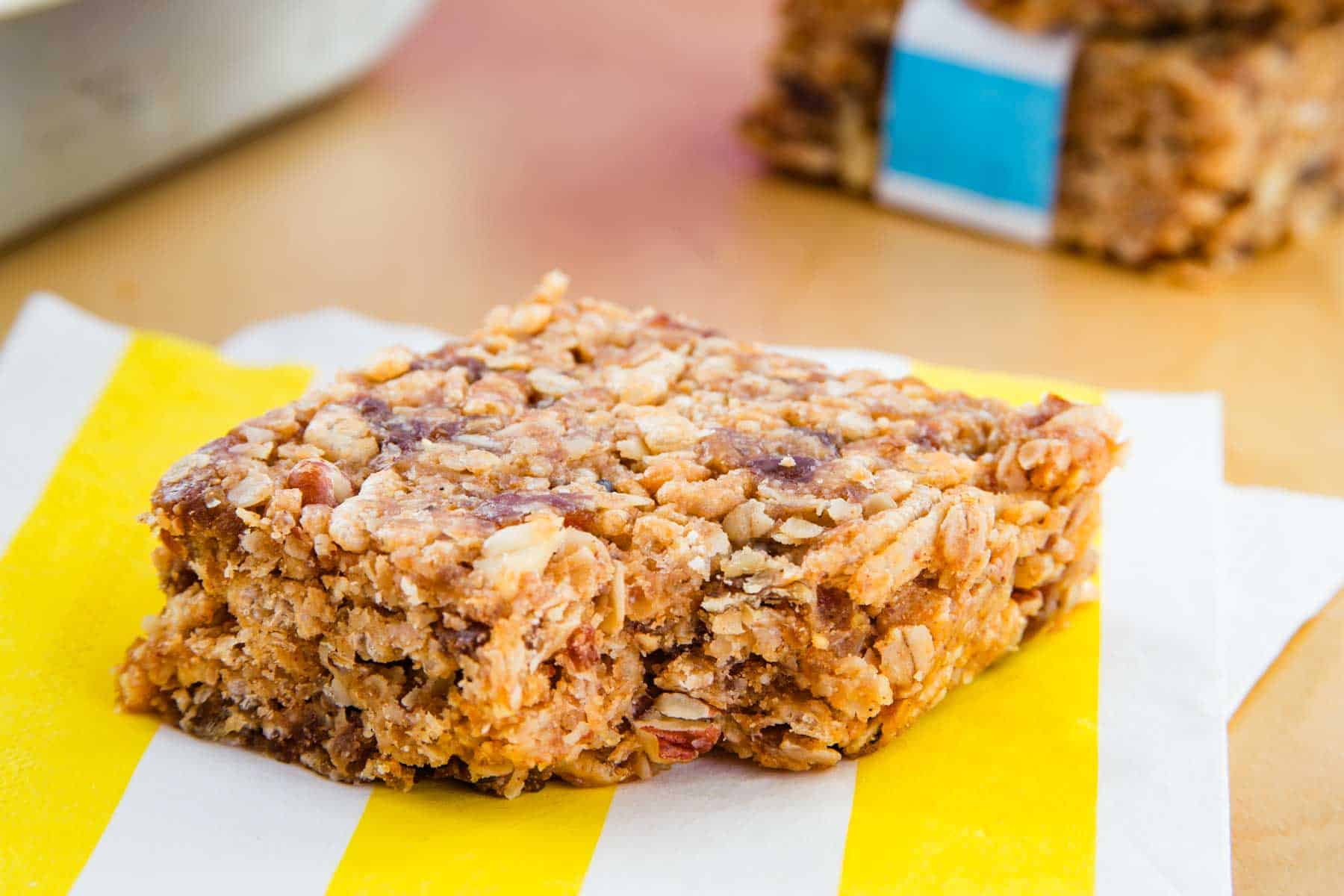 A no bake granola bar on a yellow and white striped napkin.