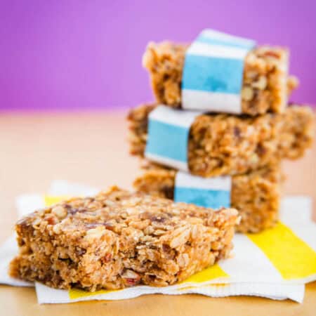 A stack of three no bake granola bars and a bar next to it.