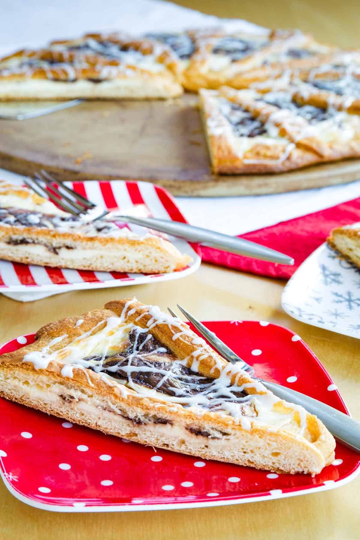 A piece of Nutella pastry is served on a plate with more slices in the background.