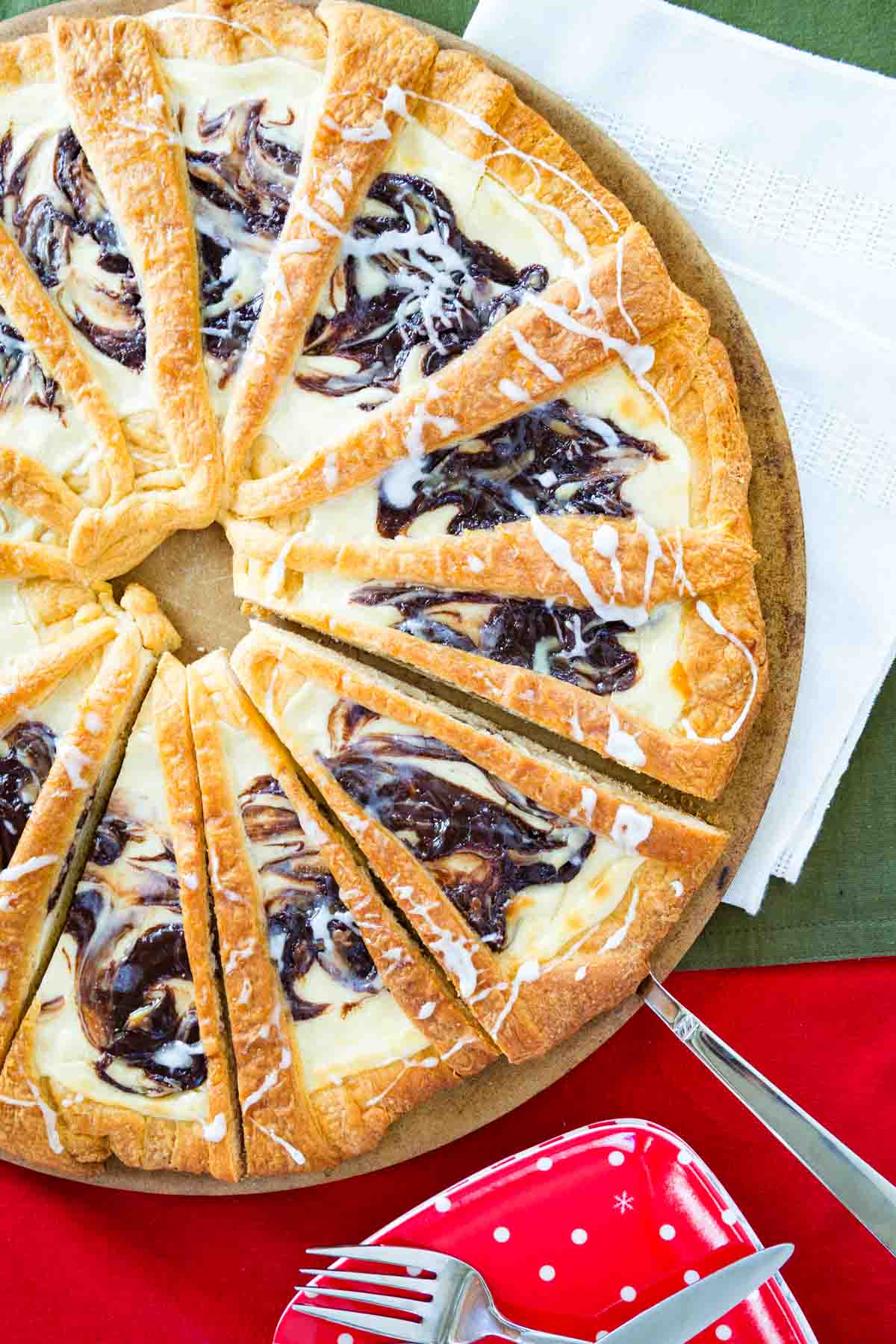 Flaky gluten-free Nutella pastry is rich and buttery, filled with a Nutella cream cheese swirl, and so easy to make! A slice of Nutella pastry is removed from the whole pastry.
