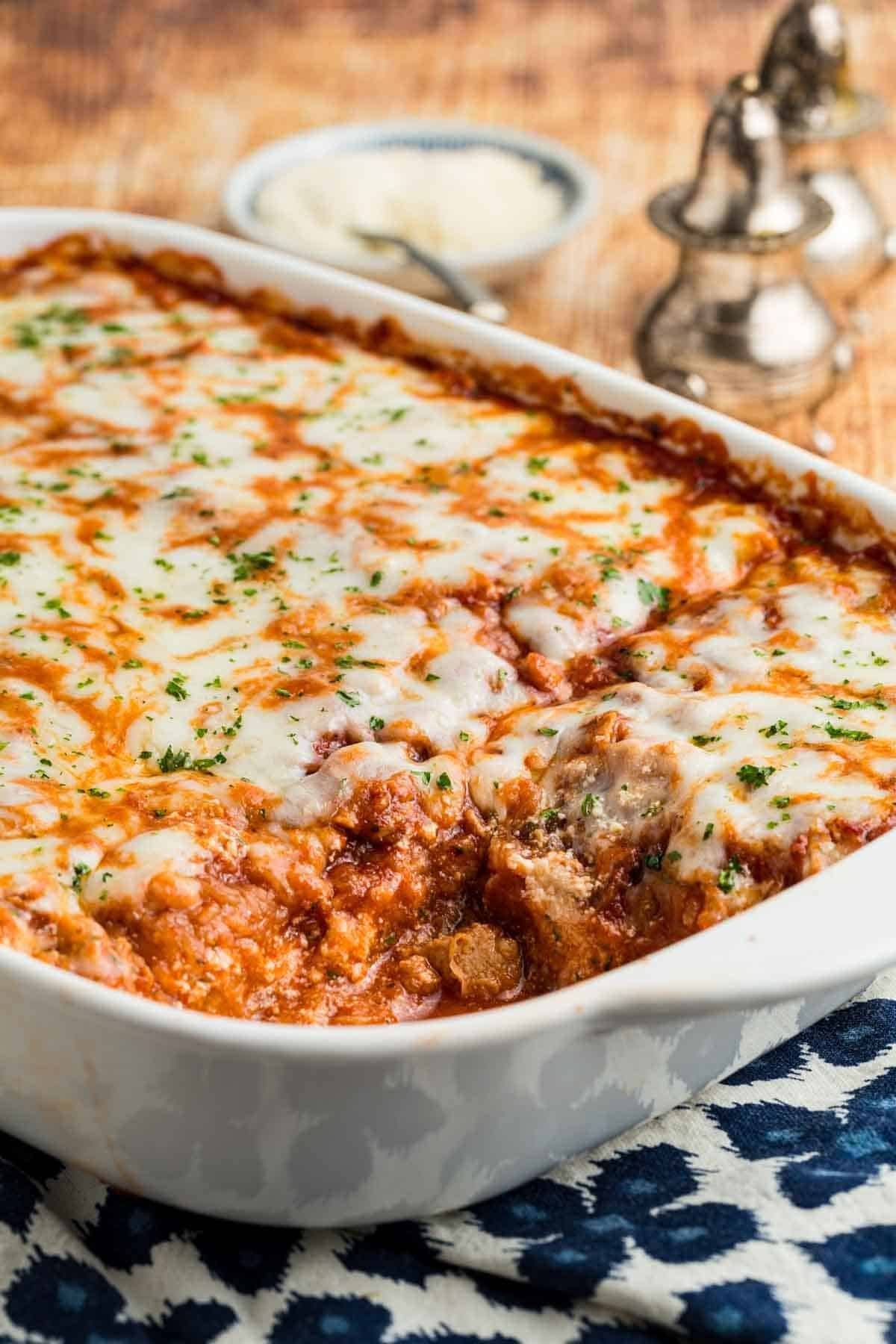 A white baking dish full of baked spaghetti squash lasagna.