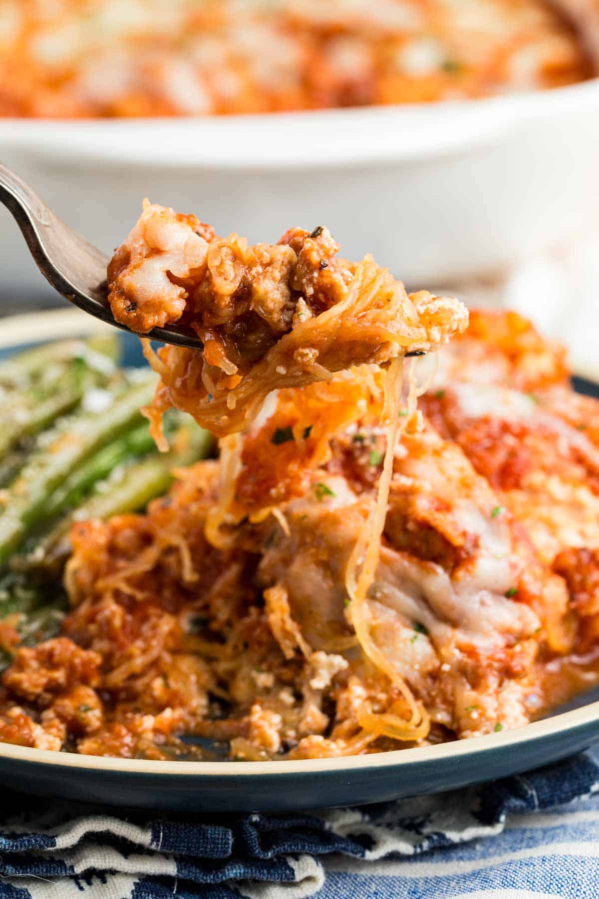 A forkful of spaghetti squash lasagna is lifted up.
