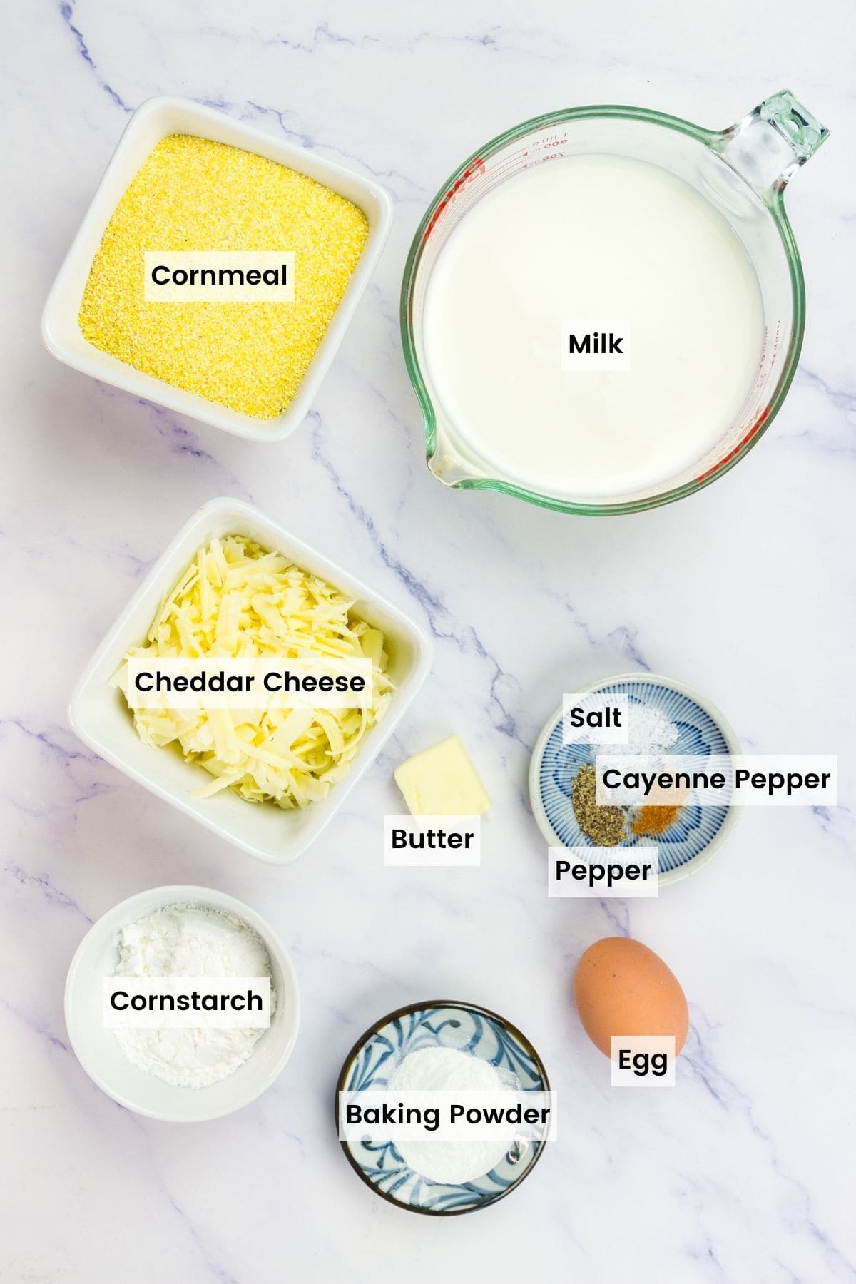 The ingredients for cheesy polenta waffles are portioned out and text-labeled.