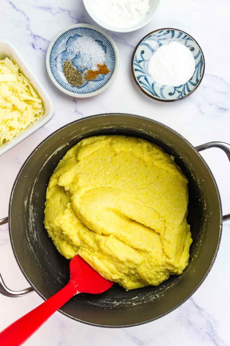 Cornmeal cooks and thickens in a pot.