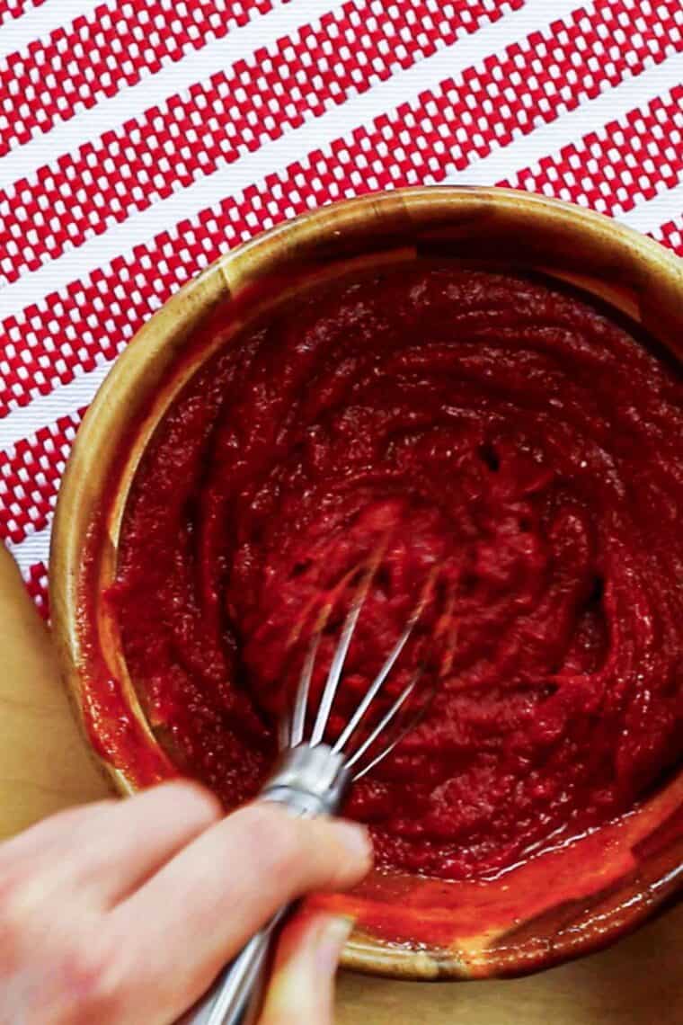 This spicy ketchup recipe makes the best homemade ketchup in just 5 minutes with a hot sauce for a kick of heat. Great on burgers! A whisk mixes together spicy ketchup ingredients until smooth.