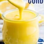 Lemon curd drizzling off a spoon into a jar with text overlay that says "Lemon Curd".