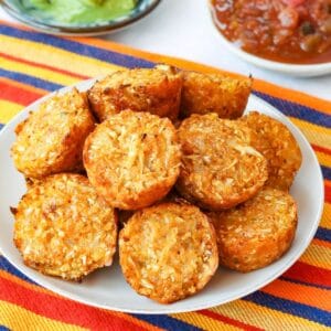 A plate of Mexican Cauliflower Tops on top of a striped cloth napkin.
