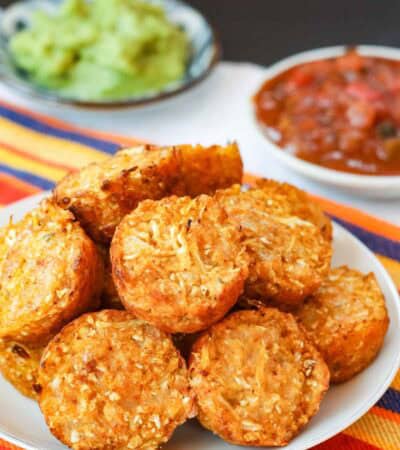 Cauliflower tots, salsa, and guacamole on a table.