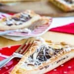 A wedge of cream cheese and Nutella filled pastry on a red polka dot plate with text overlay that says "Gluten Free Nutella Pastry".