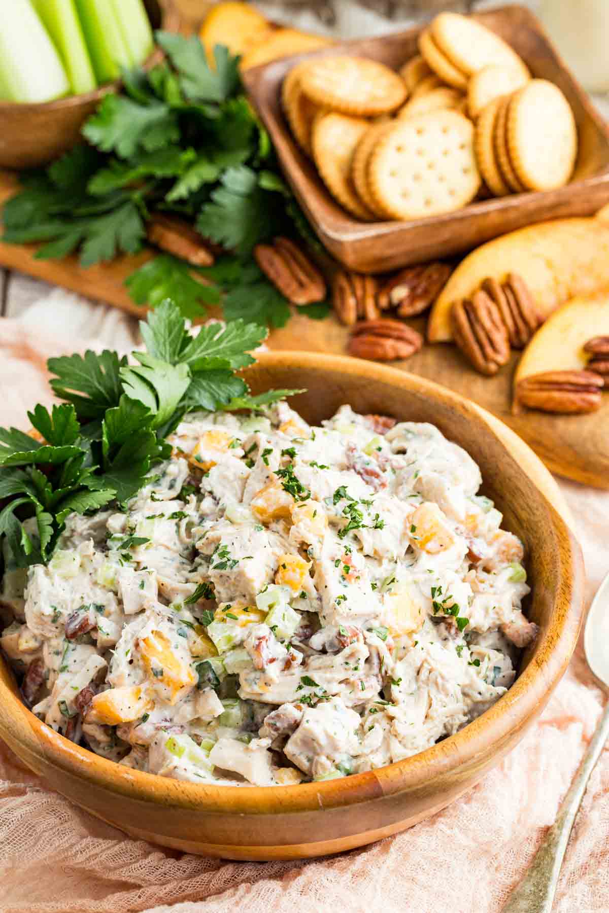 This chicken caesar salad recipe tosses crisp romaine lettuce and juicy grilled chicken in a garlicky dressing made with Greek yogurt. A bowl of pecan chicken salad with slices bread and pecans around it.