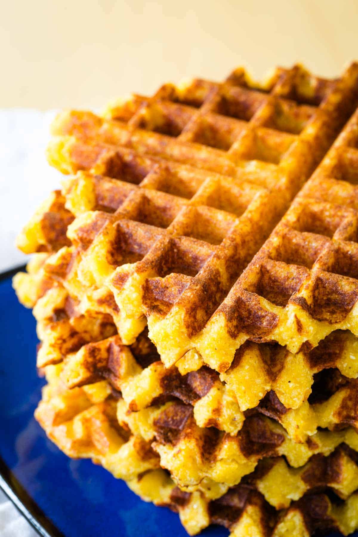 A stack of cheesy polenta waffles.