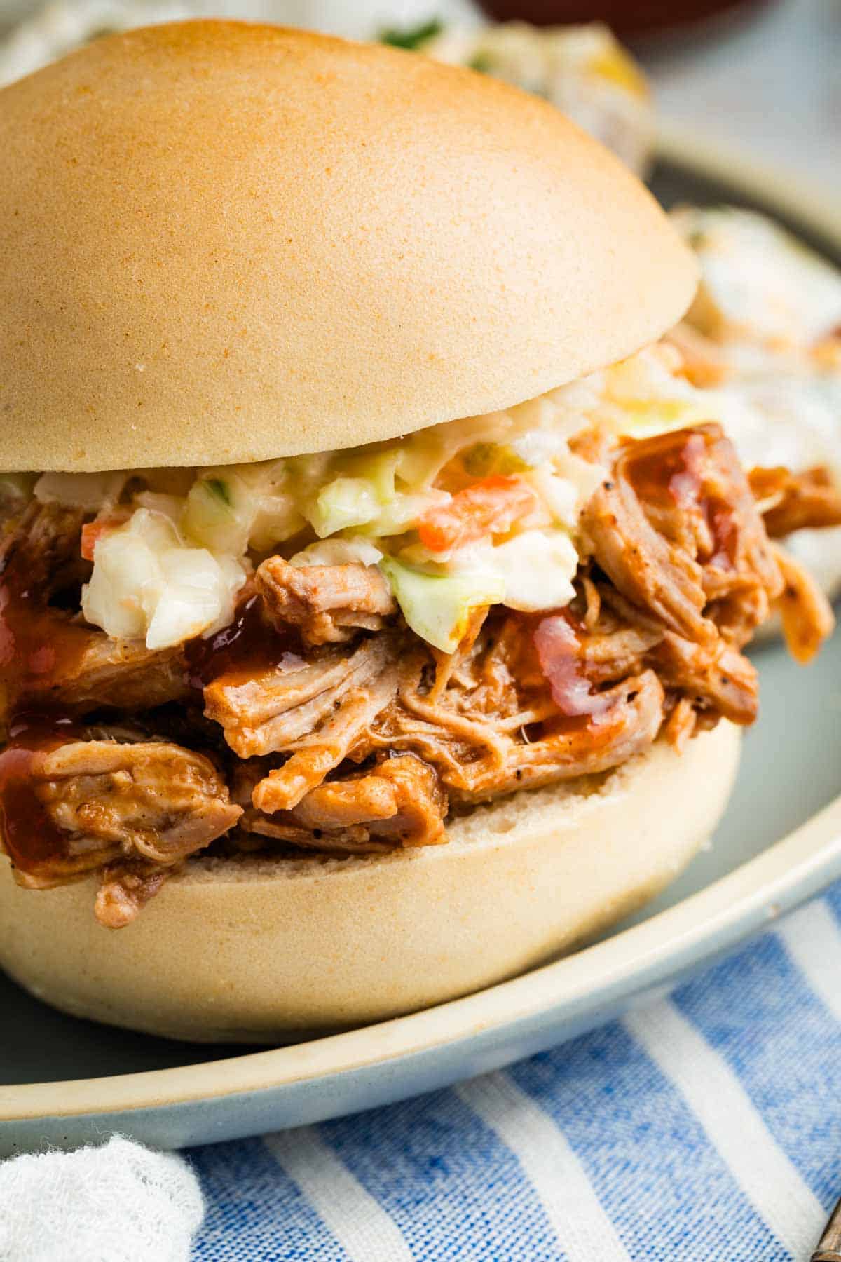 A sandwich roll holds slow cooker pulled pork.