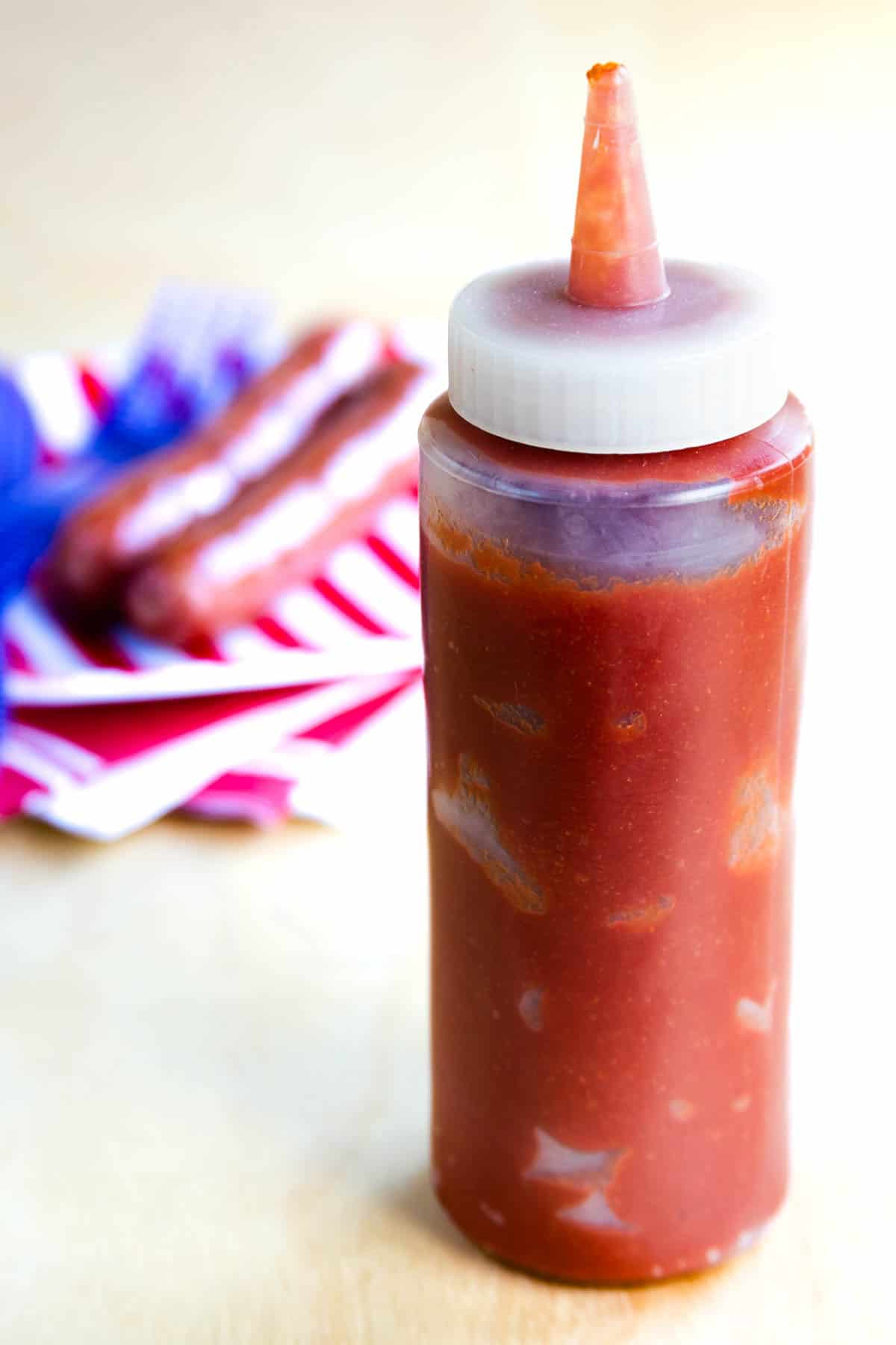 This spicy ketchup recipe makes the best homemade ketchup in just 5 minutes with a hot sauce for a kick of heat. Great on burgers! A squeeze bottle of spicy ketchup.
