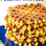 A pile of waffles on a blue plate with text overlay that says "Cheesy Polenta Waffles".